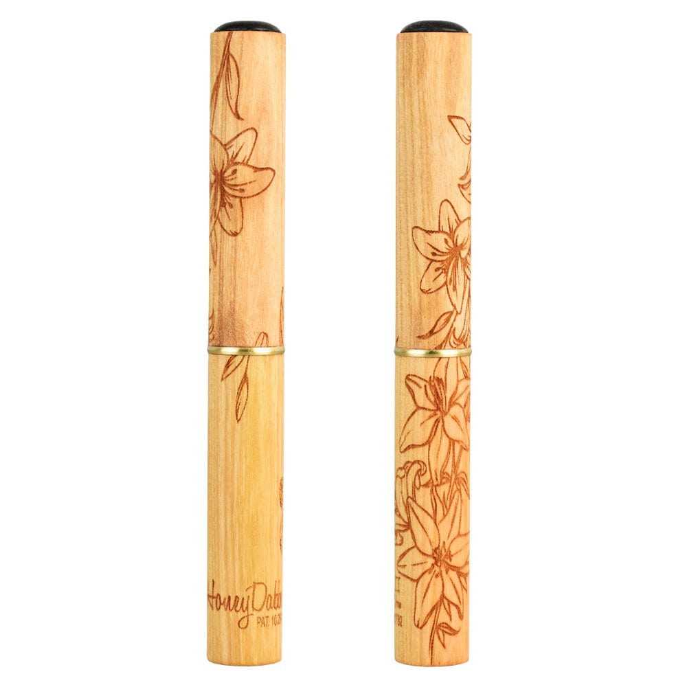 A close-up, side view of the Honey Labs Honey Dabber II Lilly Limited Edition, showing a detailed floral design on its shaft.