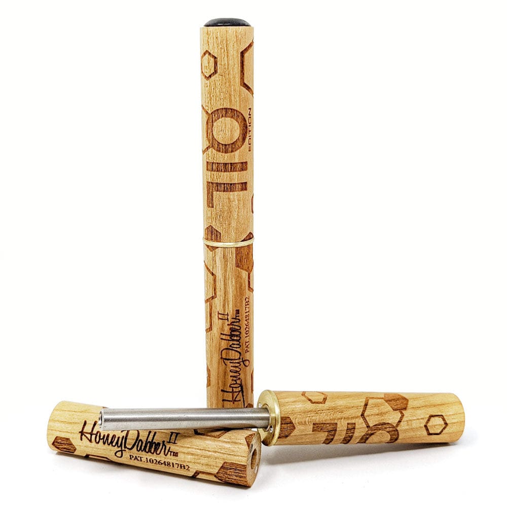 A close-up shot of the Honey Dabber II Cherry Wood Dab Straw, angled to showcase its wooden finish and slender design.