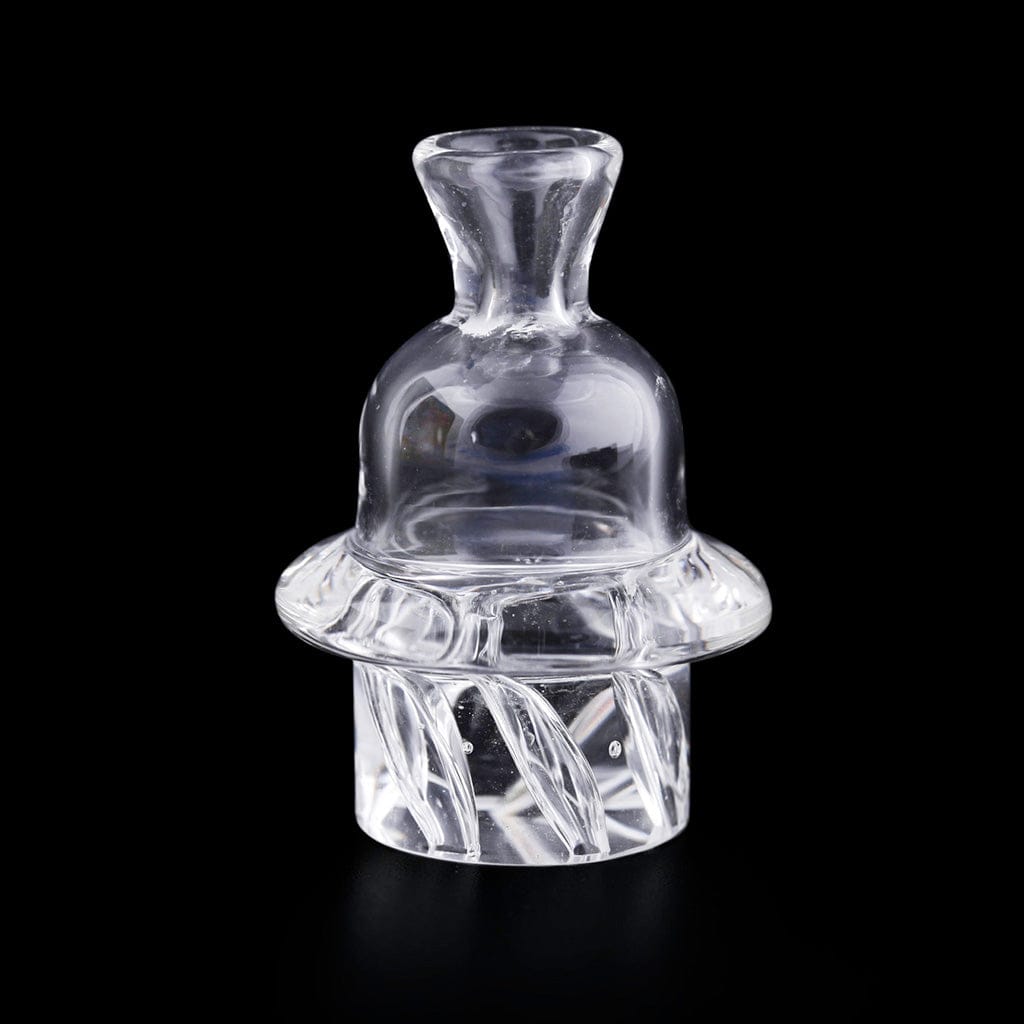 A close-up, angled view of the HONEY HIVE CARB CAP, showing its clear glass construction and rounded shape against a dark background.