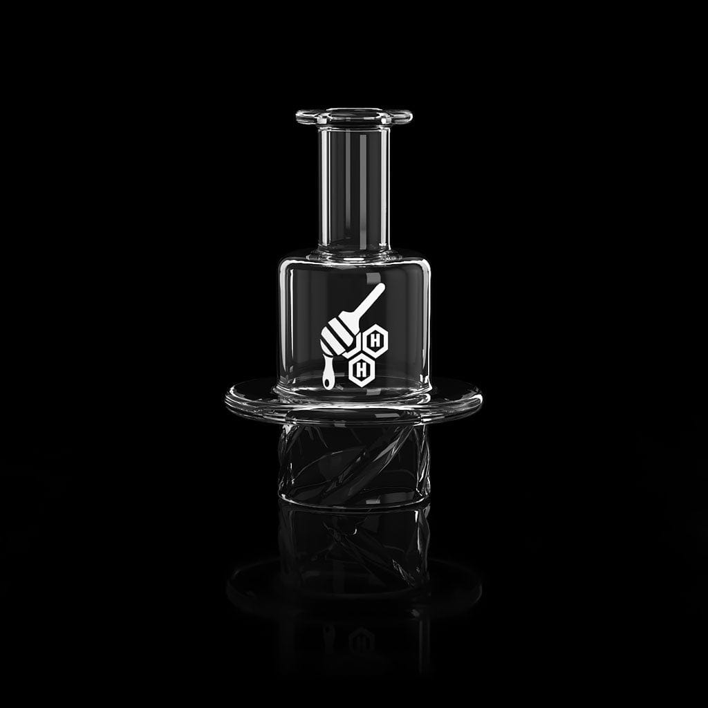 A close-up, angled view of the QUARTZ HONEY HIVE CARB CAP, showcasing its clear quartz construction and circular design.