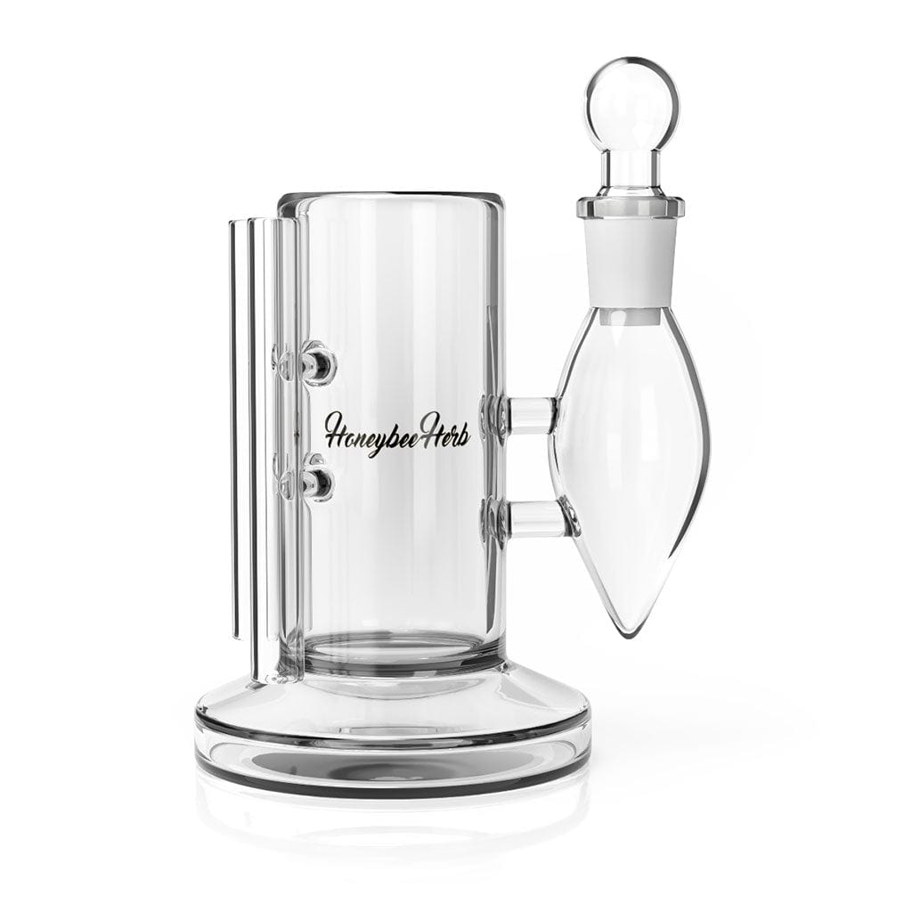 A studio shot of the Deluxe Iso Station, showcasing its clear glass construction and unique, cylindrical design.