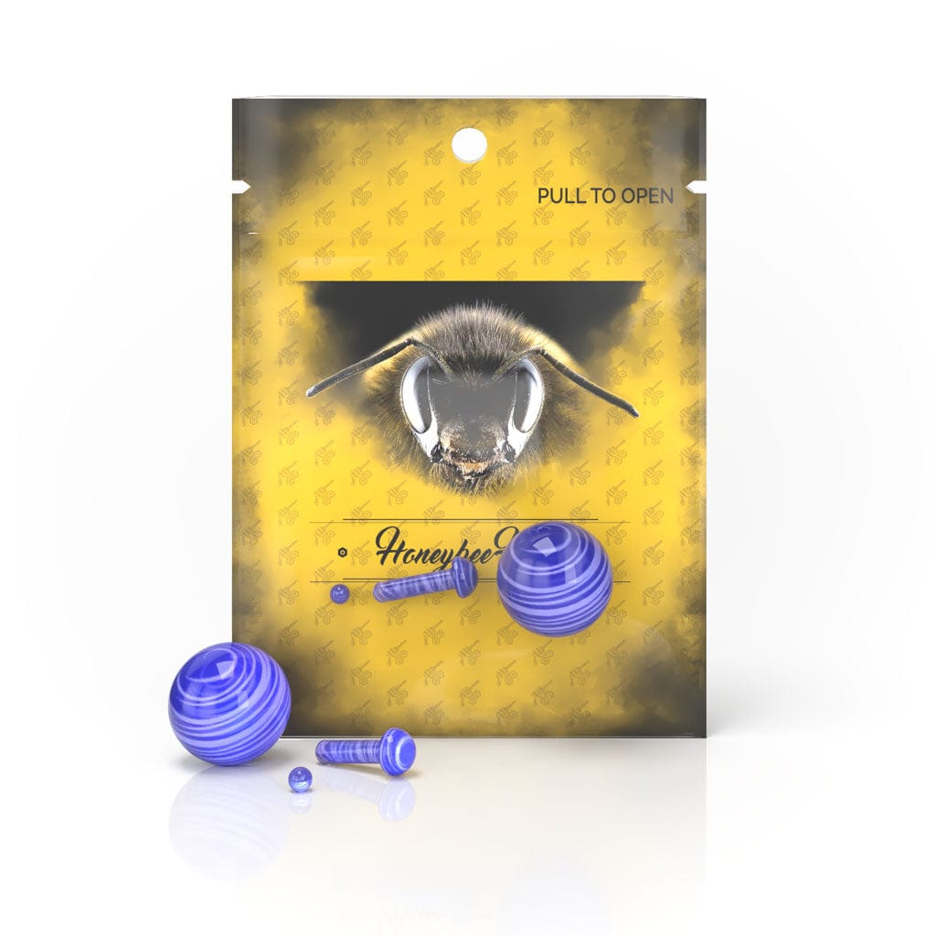 Front view of the Glass Mushroom Pillar Terp Set, showing a small, clear glass piece against a patterned yellow background.