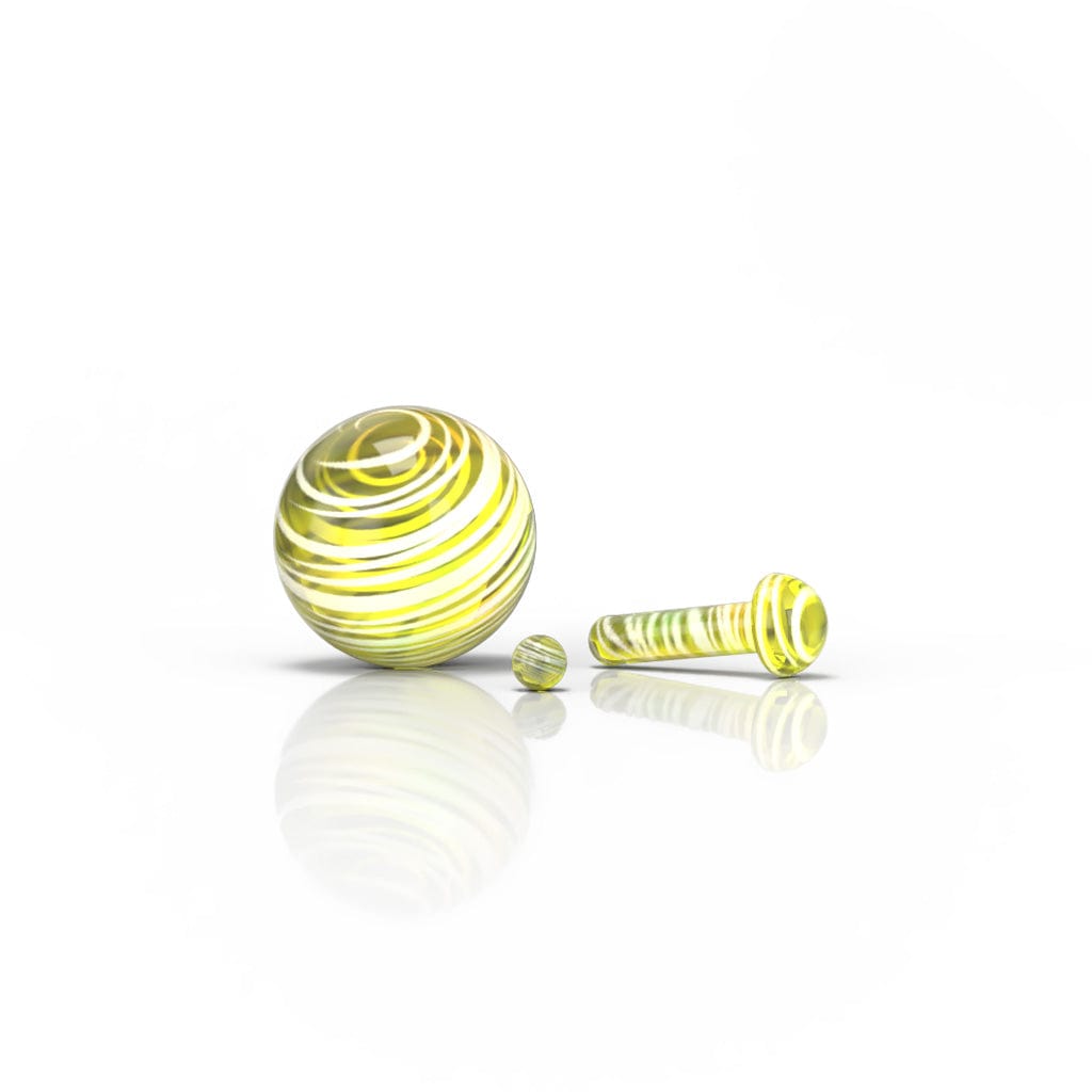 A studio shot of the Glass Mushroom Pillar Terp Set, featuring a small, rounded glass piece reflecting light on a white surface.