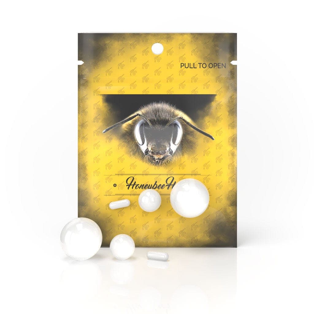 A close-up, top-down view of the Honeybee Herb Dab Marble Set, showing the collection of small, translucent marbles.