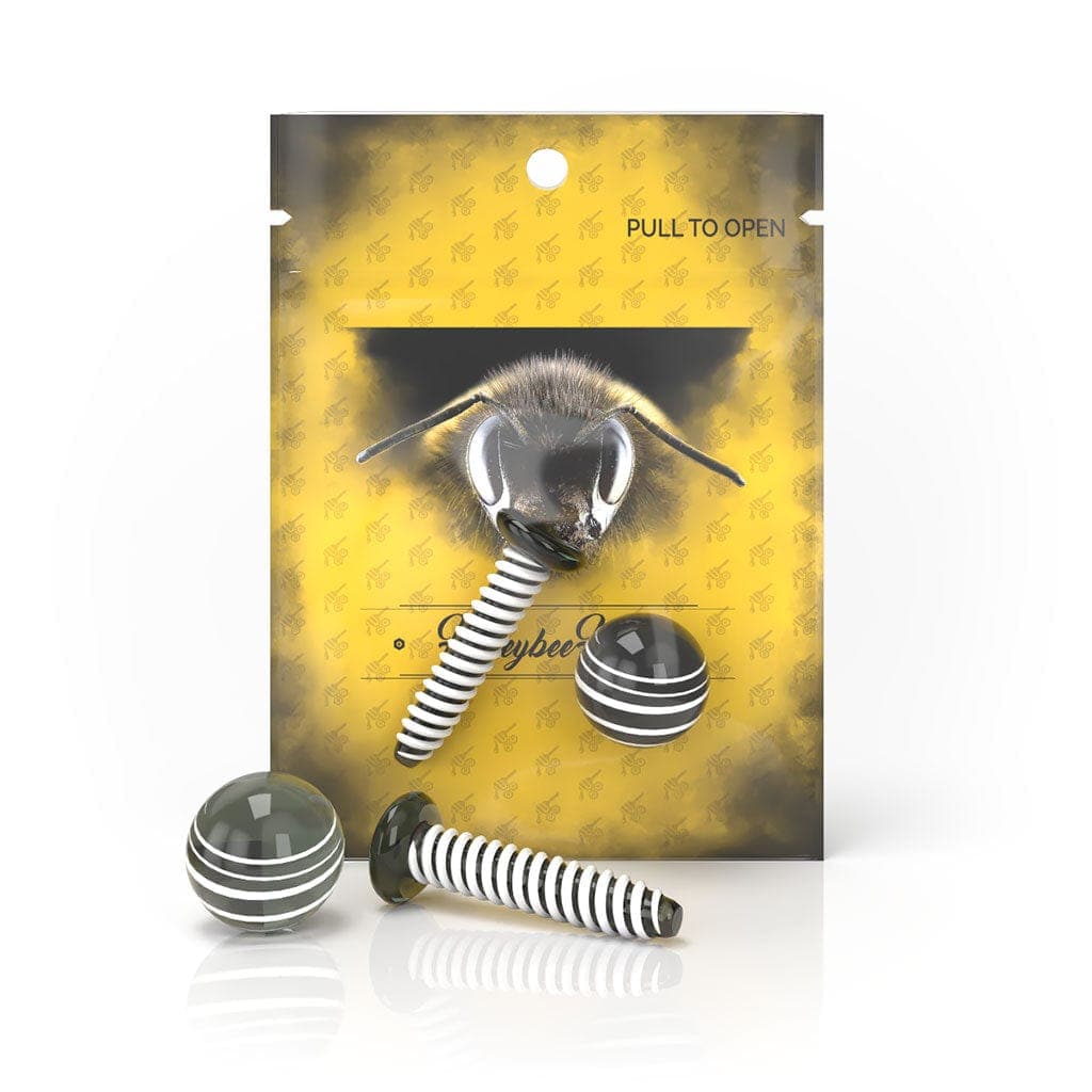 A close-up shot of the Honeybee Herb Dab Screw Set, showing a small, silver screw against a patterned yellow background.