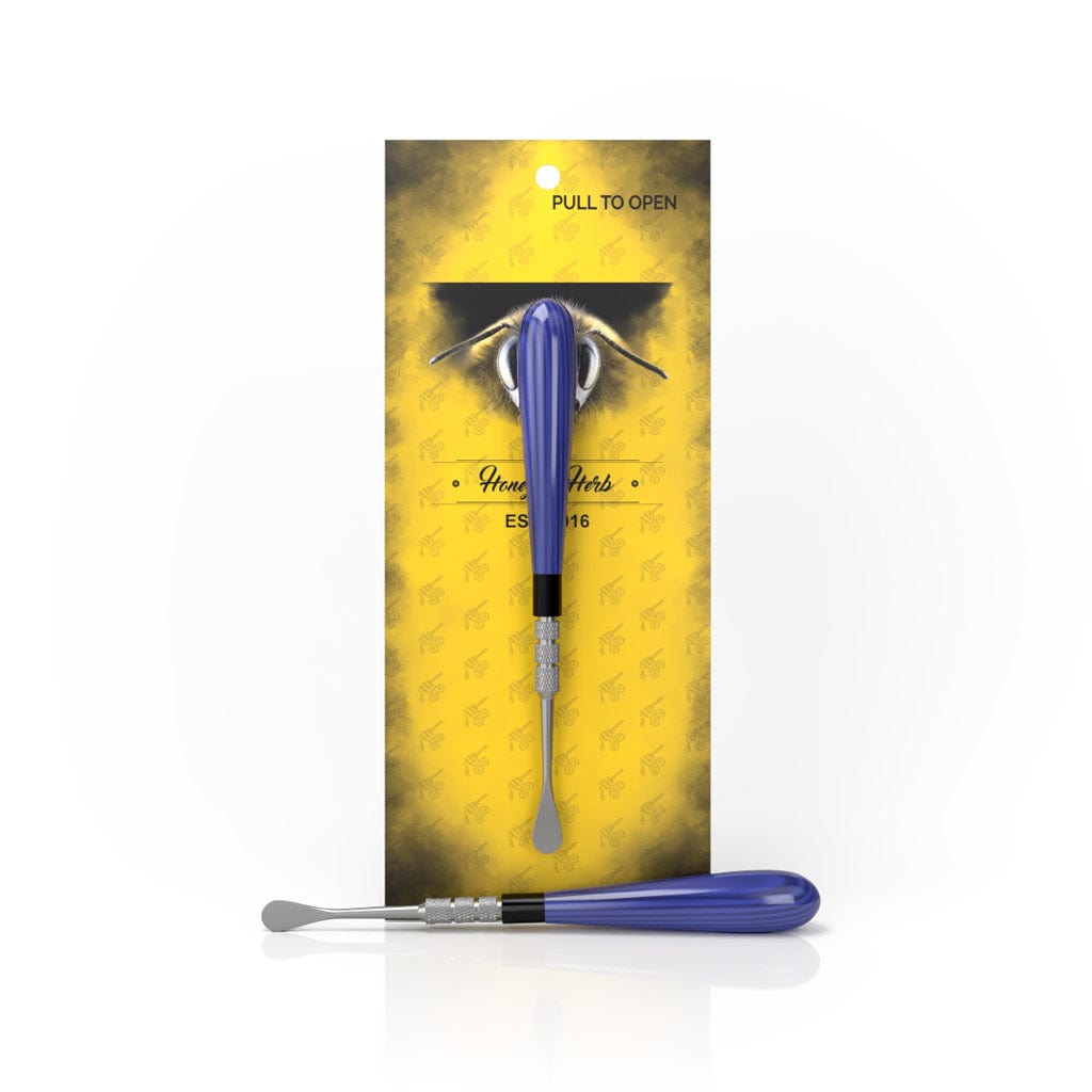 A close-up shot of the Classic Dab Tool, showing its silver metal tip against a yellow background.