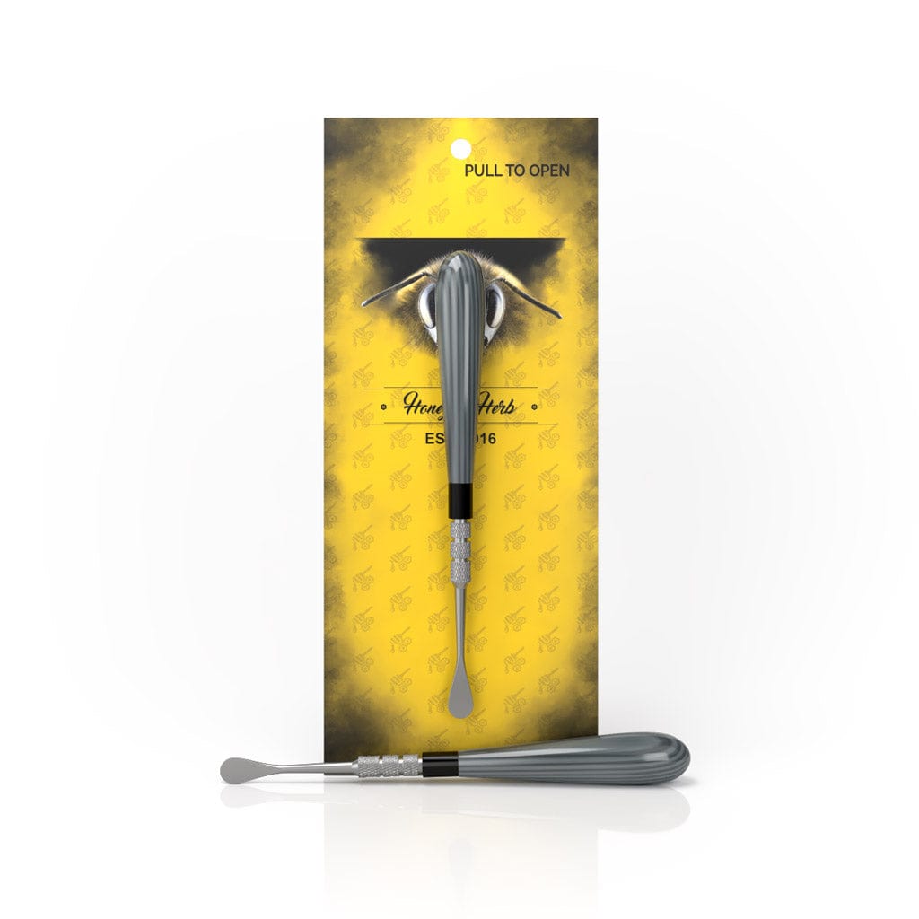 A close-up shot of the Classic Dab Tool, displayed against a yellow background with text that reads “Pull to Open.”