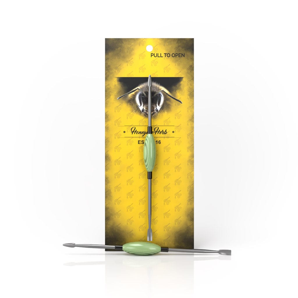 A close-up shot of the Oval Dab Tool, showcasing its sleek design against a vibrant yellow background.