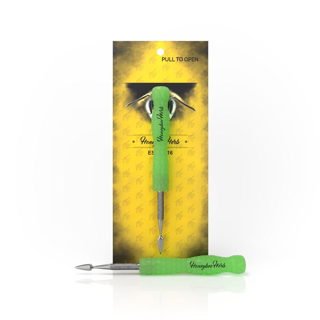Front view of the Honeybee Herb Glow In The Dark Dab Tool showing a bright blue-green handled double-ended metal tool against its yellow branded backing card.