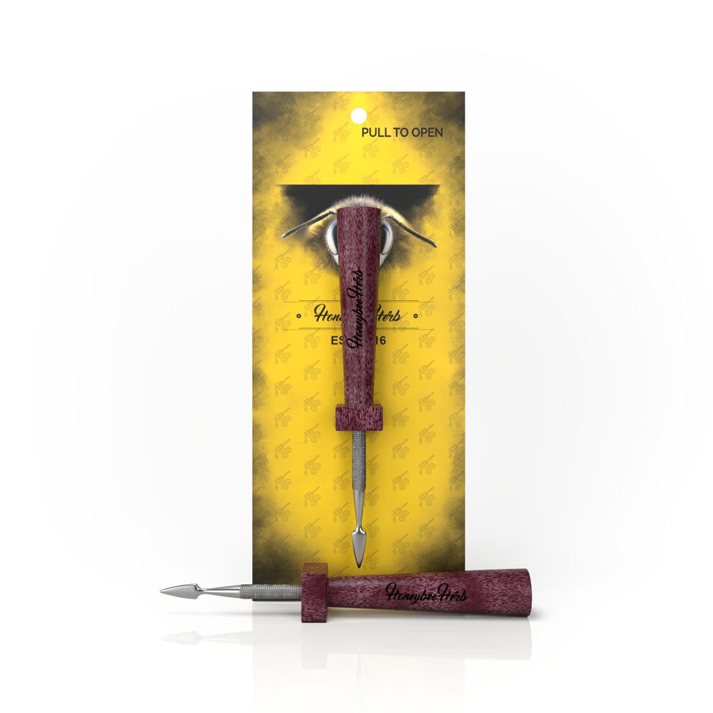 Front view of the Classic Resin Dab Tool with a metallic tip and wooden handle against a patterned backdrop.