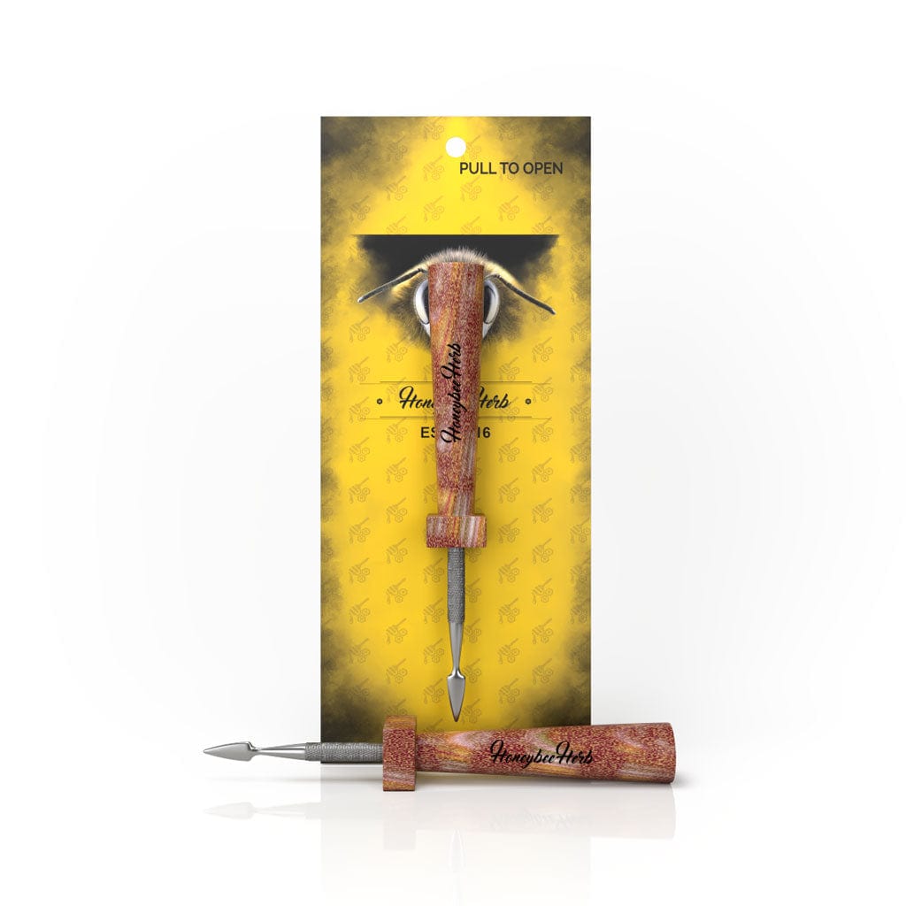 Front view of the Classic Resin Dab Tool, featuring a silver tip and dark handle against a patterned background.