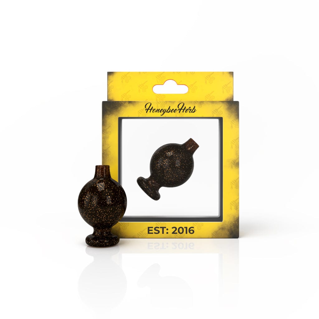 A close-up shot of the GALAXY BUBBLE CARB CAP, displaying a dark, speckled surface with a rounded shape and smooth finish.