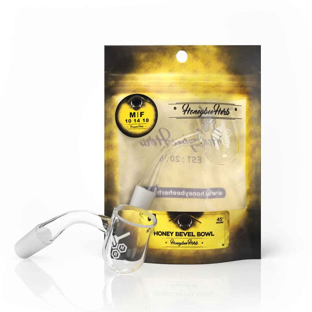 Angled close-up of the Honey Bevel Bowl Quartz Banger - 45Â° Degree | Yl showing its 45° joint and clear glass bowl resting in front of branded yellow packaging.