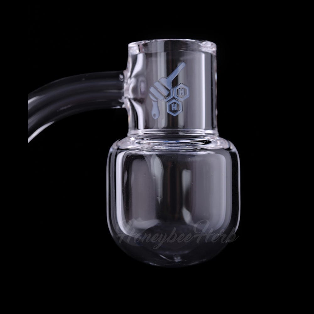 A close-up, angled view of the HONEY KETTLE QUARTZ BANGER - 45° DEGREE  YL, showing its clear quartz construction and angled joint.