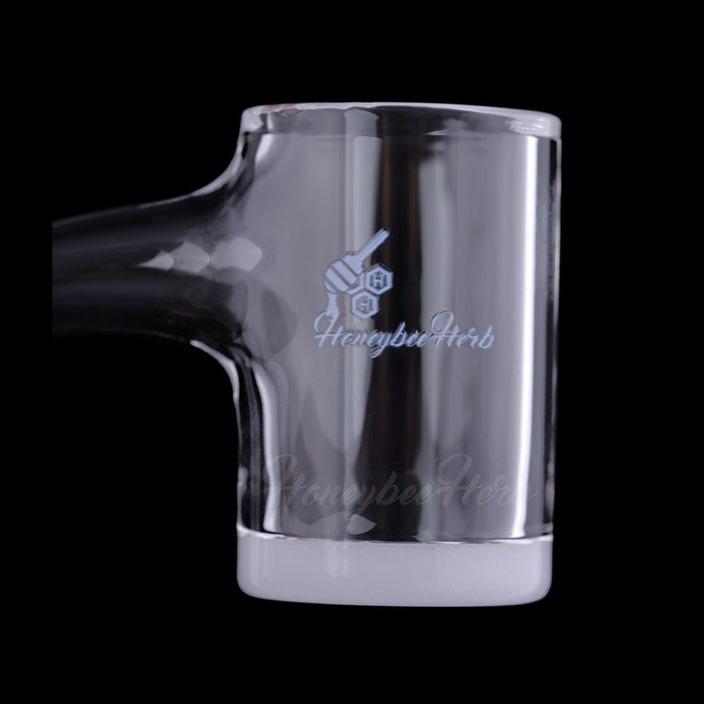Close-up side view of the Honey & Milk Bevel Quartz Banger- 90Â° Degree | Bl showing its clear glass cup, beveled frosted joint base, and subtle HoneybeeHerb logo against a black background.