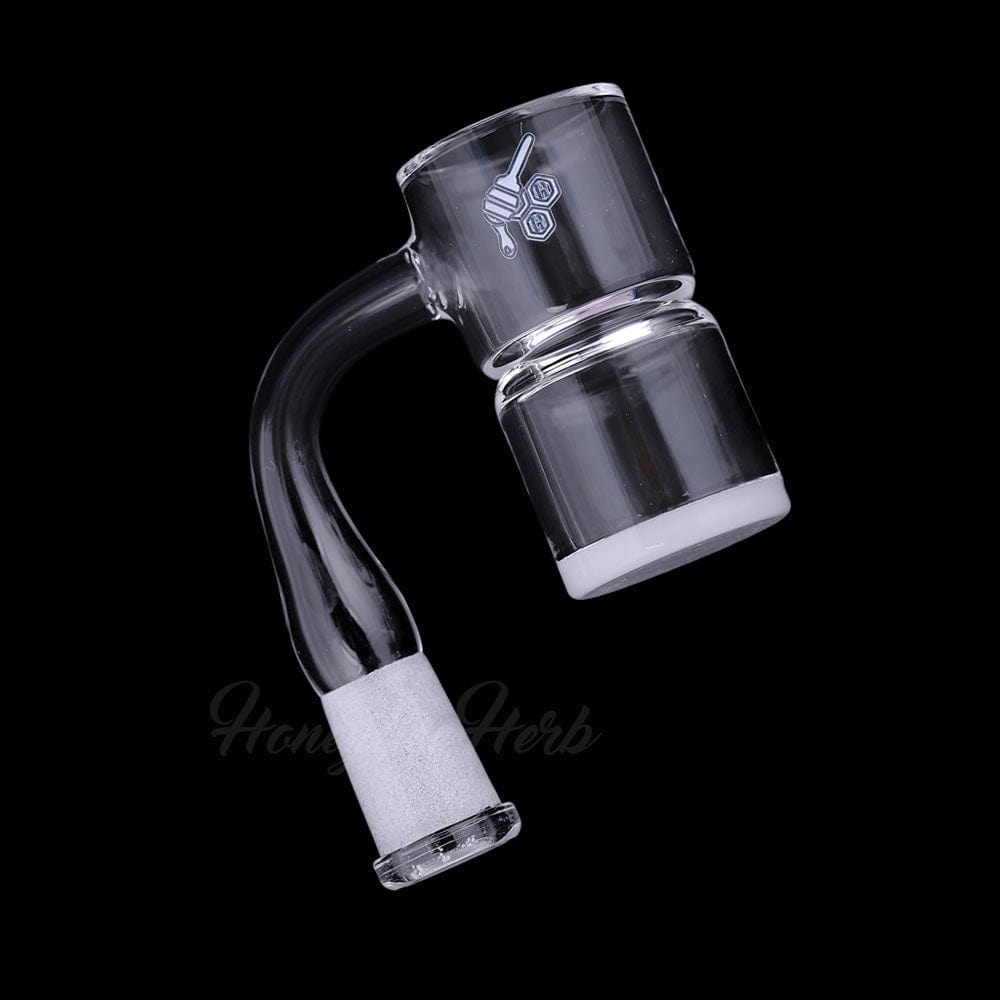 Close-up three-quarter view of the HONEY & MILK BEVEL SPLASH BUCKET QUARTZ BANGER - 90Â° DEGREE | YL showing its curved 90° neck, frosted 18mm male joint, and clear bevelled bucket against a black background