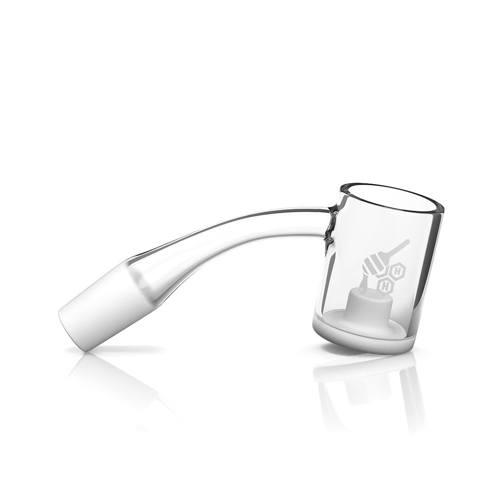 Angled studio shot of the HONEY & MILK CORE REACTOR QUARTZ BANGER - 45Â° DEGREE | YL showing a clear 45-degree bent quartz arm and bucket with etched honeycomb logo on a white reflective background