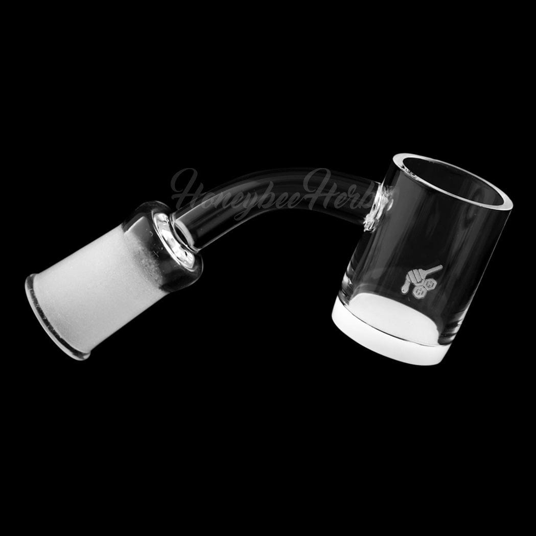 A tilted, close-up view of the HONEY & MILK QUARTZ BANGER - 45° DEGREE, showcasing its clear quartz construction and angled design.