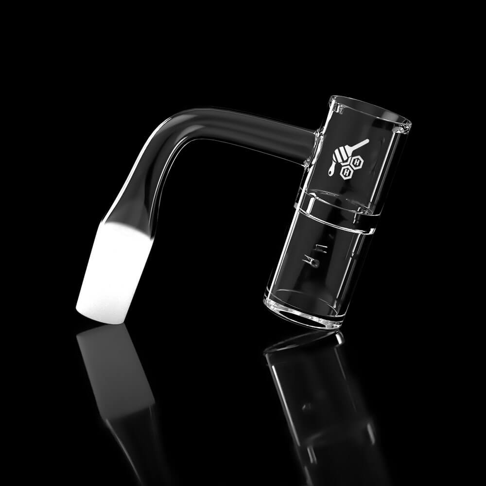 A studio shot of the HONEY WELL QUARTZ BANGER - 90° DEGREE, displaying its clear quartz construction and angled design against a dark reflective surface.
