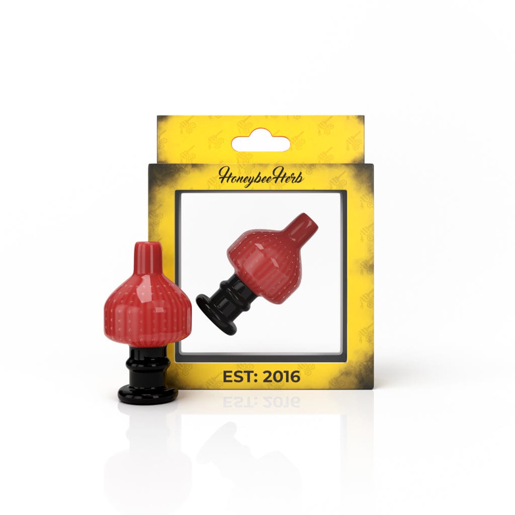 Close-up of the SWEET BUBBLE CARB CAP, a colorful glass cap angled against a dark background.