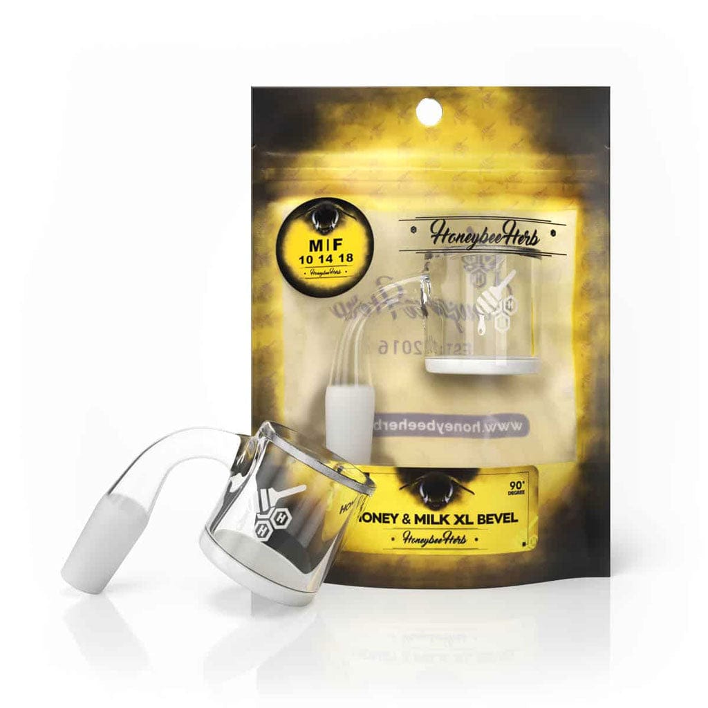 Angled close-up of the HONEY & MILK XL BEVEL QUARTZ BANGER - 90Â° DEGREE | YL showing the clear beveled quartz bucket and 90° joint against its yellow branded packaging.