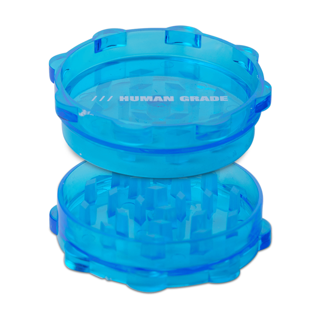 An eye-level shot of the Acrylic 2.5" Grinder, a single-piece, translucent blue grinder with a textured surface.