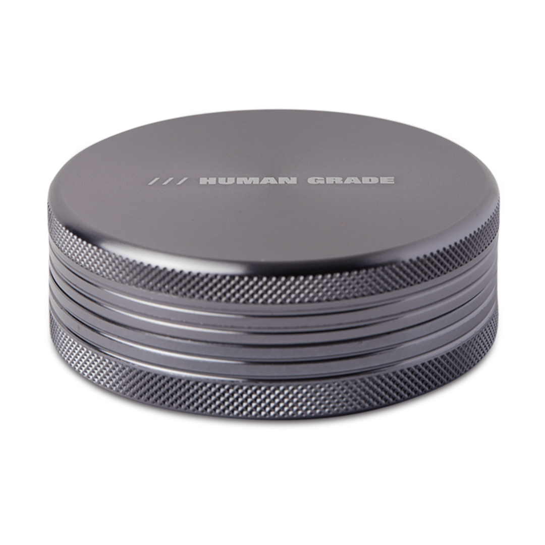 Front view of the Human Grade Grinder 1C (2.5") with a sleek, metallic finish and a textured, two-piece design.