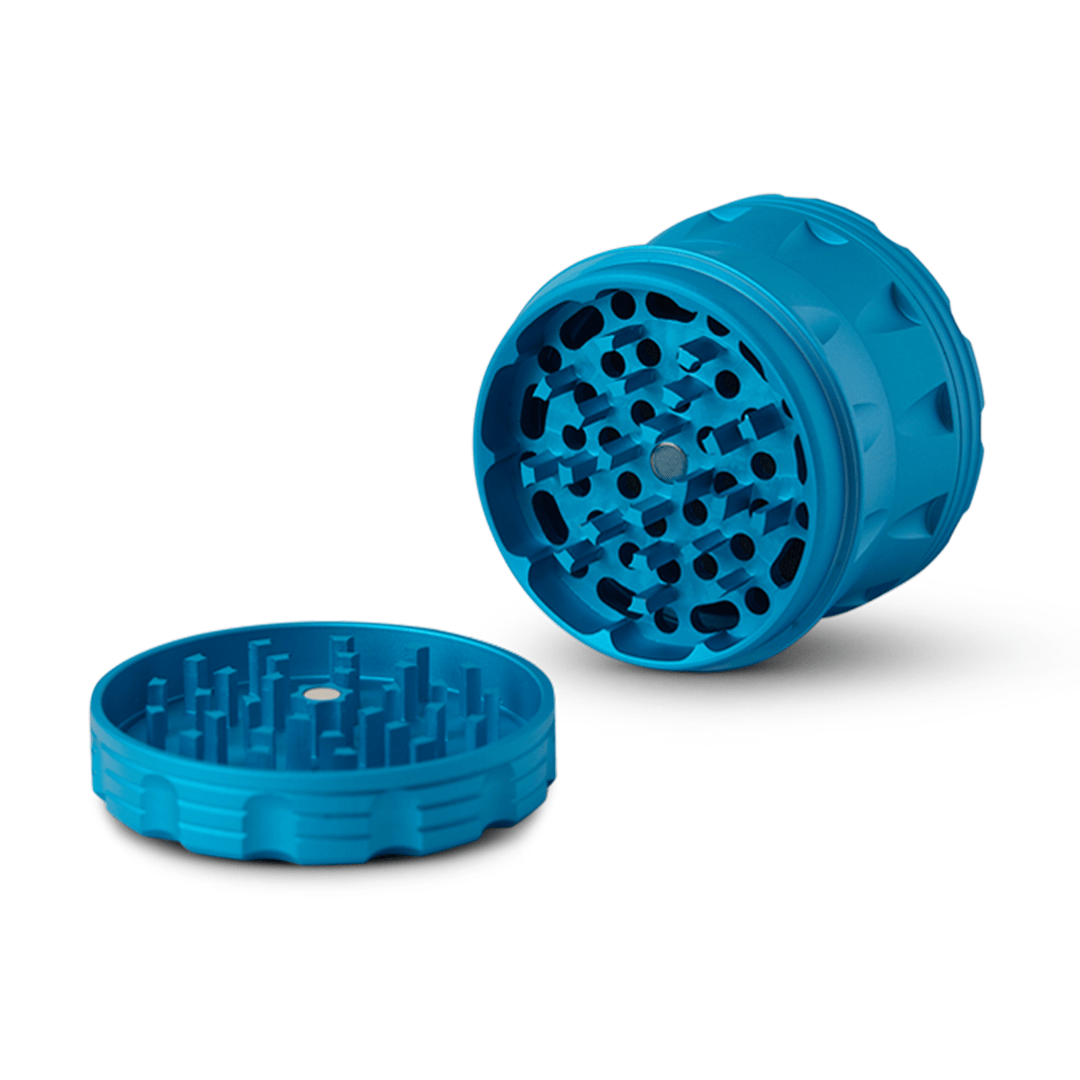 A top-down view of the open Human Grade Grinder 2A (2.5" 4-Piece) with its multiple grinding teeth clearly visible against a white background.