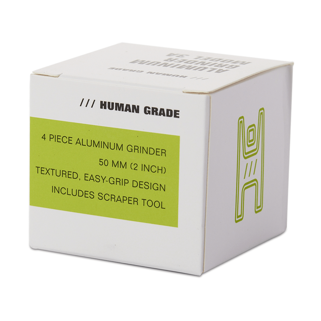 Front view of the Human Grade Grinder 3A (2" 4-Piece) showcasing its metallic finish and segmented design.