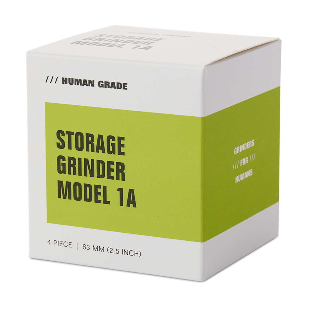 Front view of the Human Grade Storage Grinder 1A (2.5"), showing a simple, cylindrical shape with text on its side.
