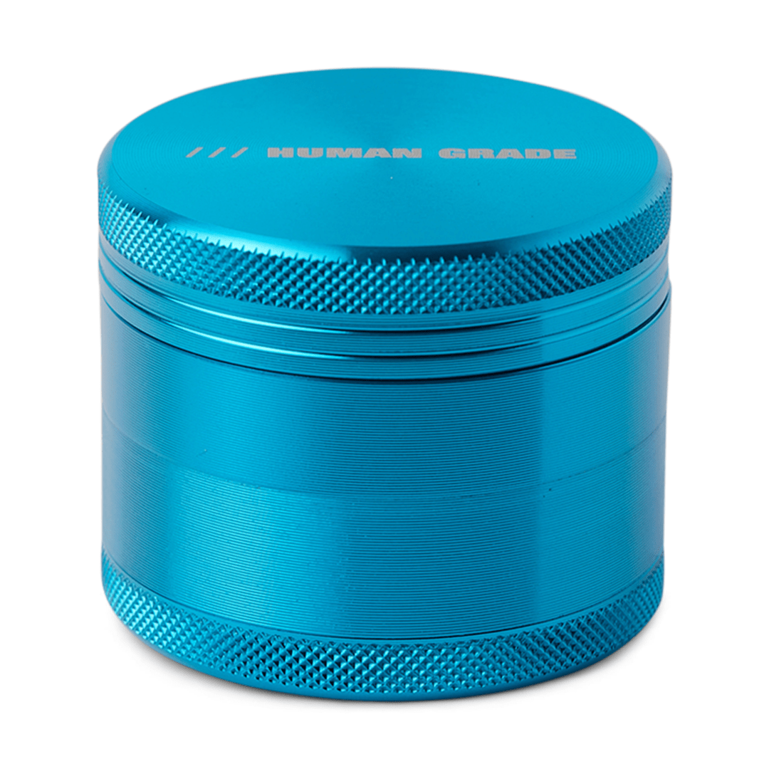 Close-up of the Human Grade Grinder 1A (2") featuring a metallic, textured surface and a cylindrical shape.
