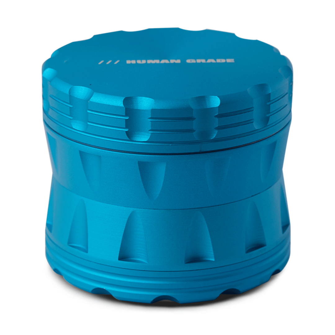 A close-up, angled view of the Human Grade Grinder 2A (2.5" 4-Piece) featuring a silver, multi-tiered design.