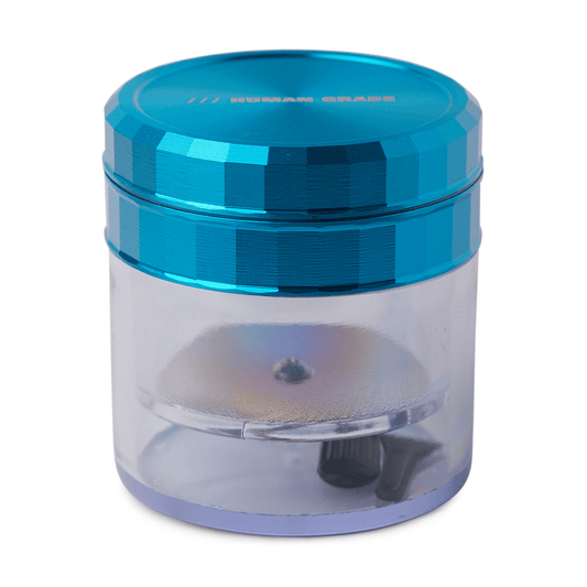 Front view of the Human Grade Storage Grinder 1A (2.5") with a clear chamber and dark blue lid.