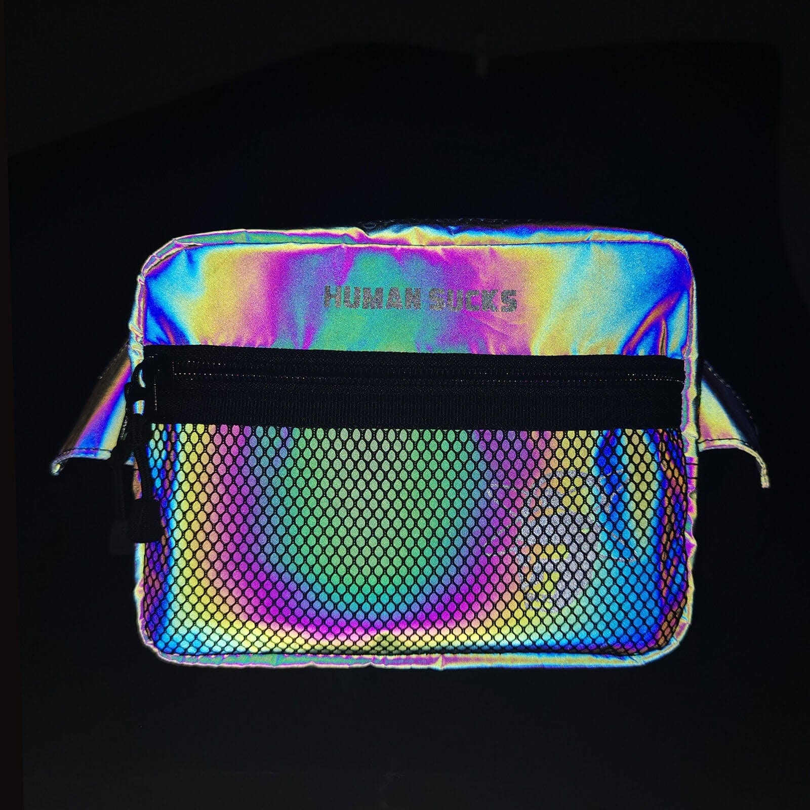 Front view of the HUMAN SUCKS Reflect Fanny Pack, a metallic silver pouch angled on a black background.