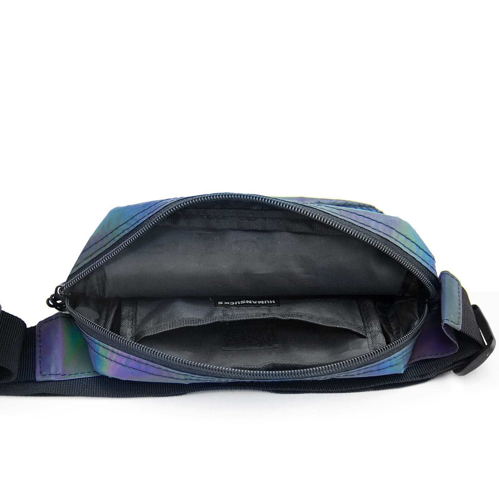 A close-up view of the open main compartment on the HUMAN SUCKS Reflect Fanny Pack, revealing its black interior lining.