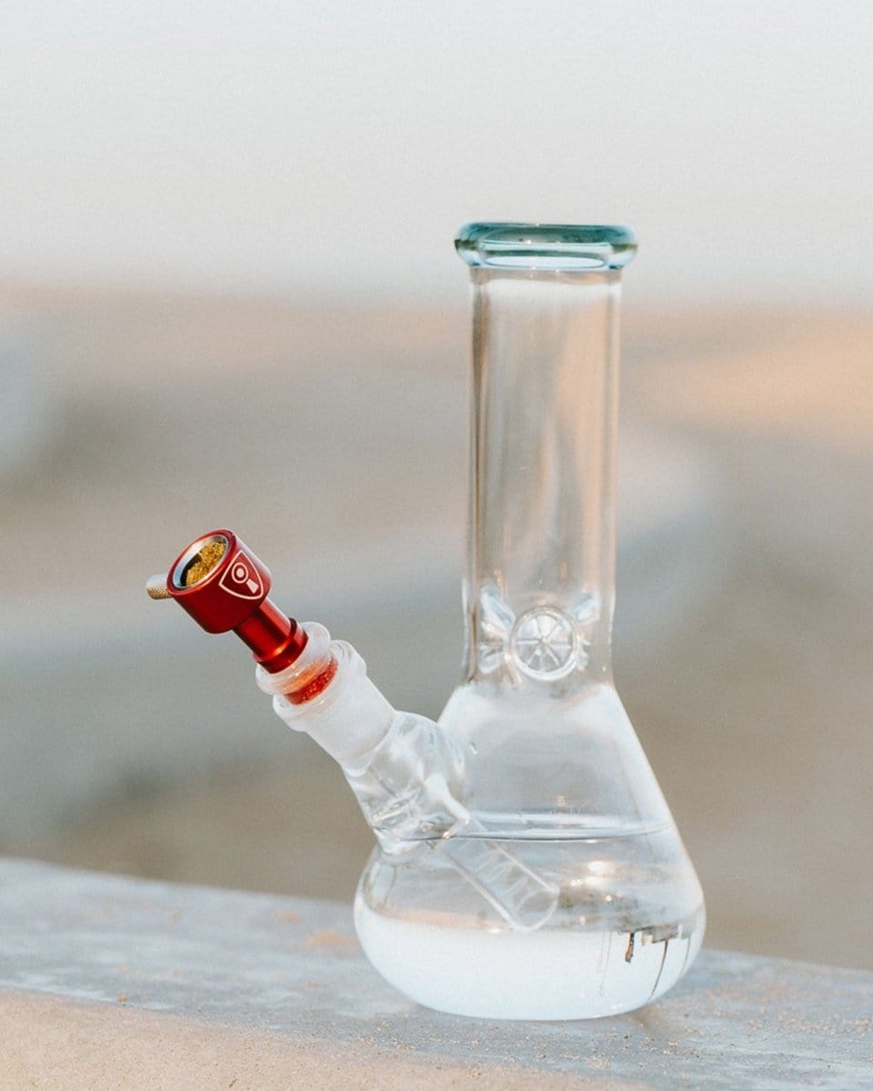 A close-up shot of the Indestructible Bong Bowl, highlighting its clear glass construction and simple, rounded shape.