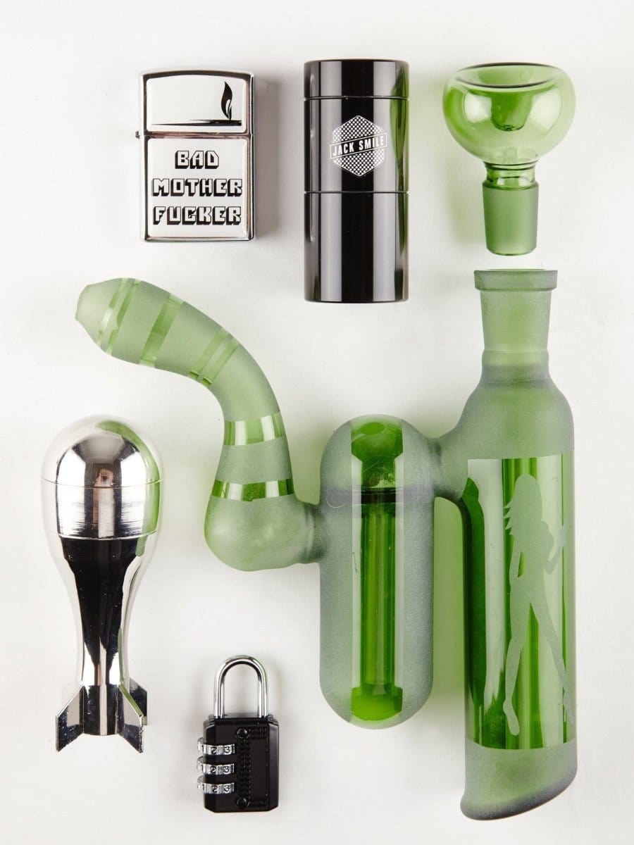 Front view of the First Aid Smoking Kit, showing a black metal container alongside a clear glass piece.