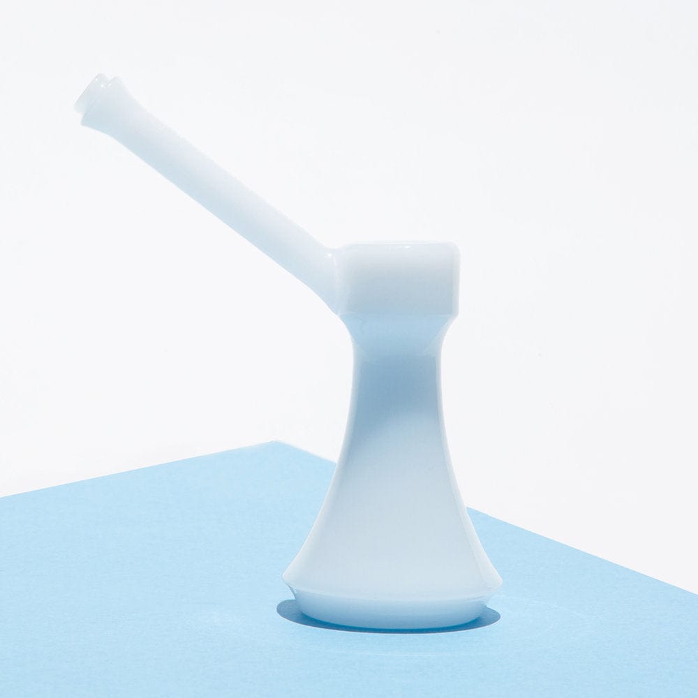 A minimalist, angled view showcases The Bubbler By Jane West, with its sleek form rising from a textured blue surface.