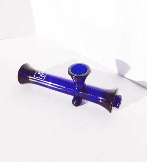 A studio shot of The Steamroller By Jane West, a clear glass pipe angled slightly against a plain white backdrop.