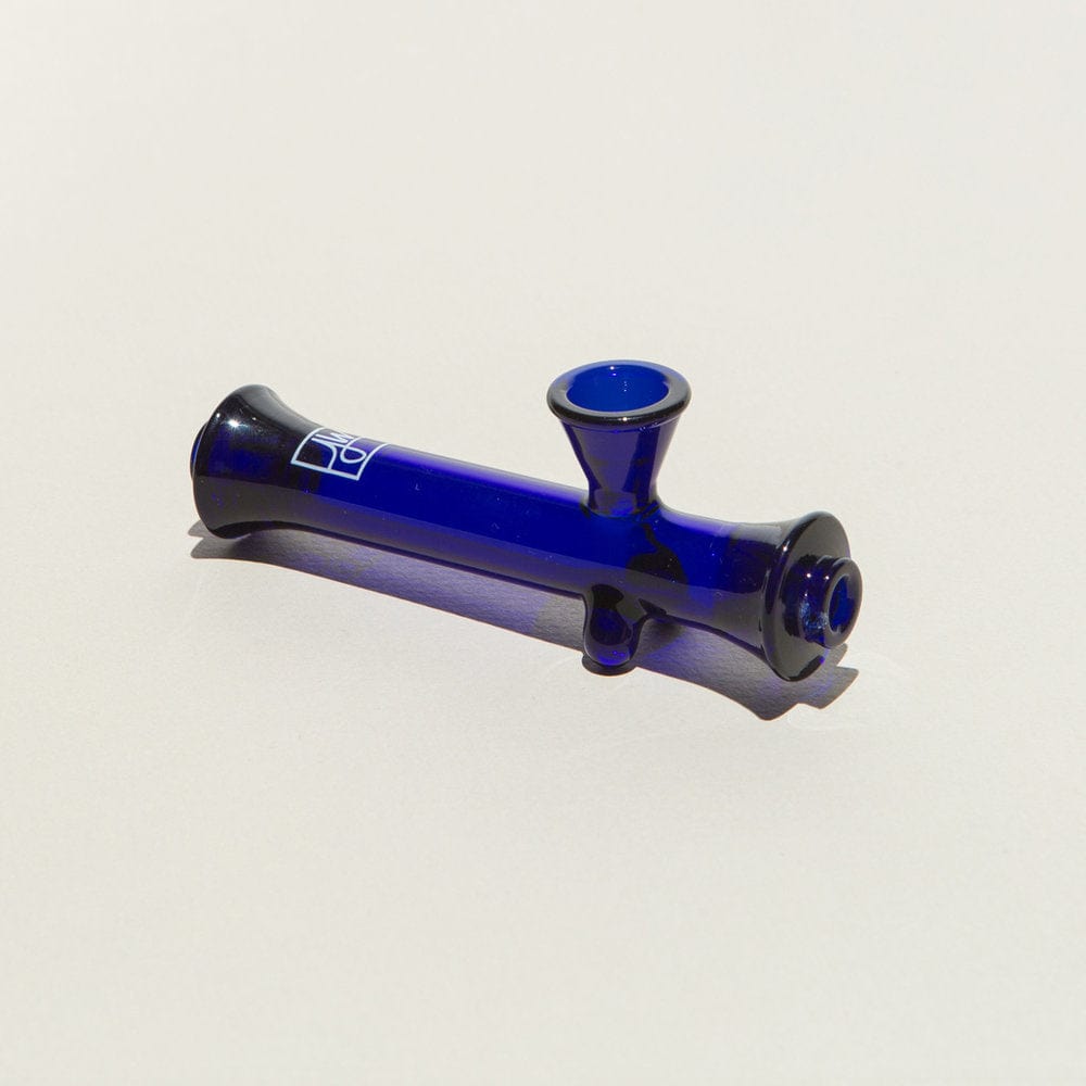 Front view of The Steamroller By Jane West, a blue glass pipe angled slightly against a muted gray background.