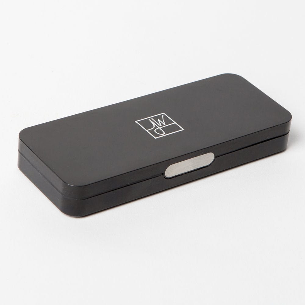 The Compact sits on a white surface, presented in a slightly angled, high-key studio shot.