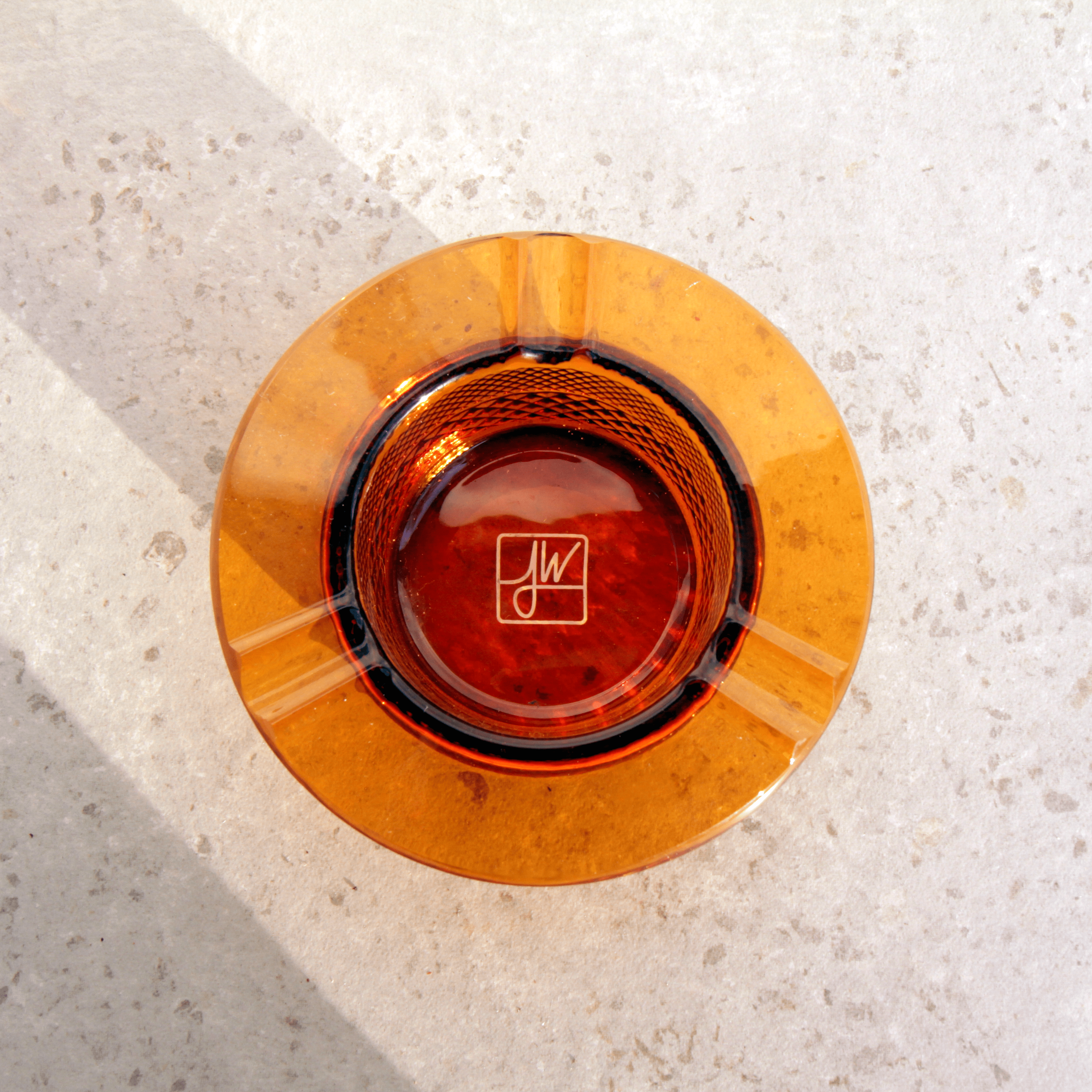 Overhead view of the Jane West Twenties Collection Ashtray, showcasing its circular shape and reflective interior on a light surface.