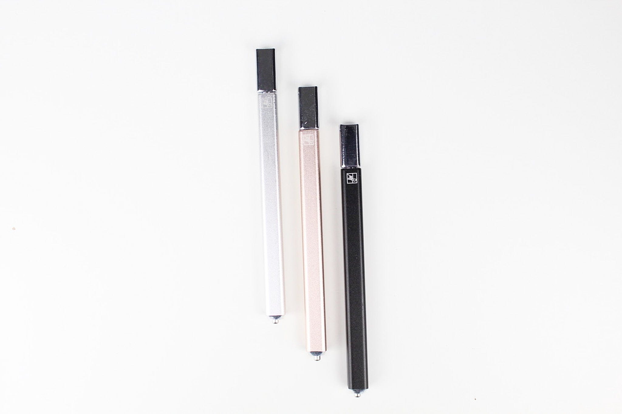 Front view of The Trio, three slender, dark-colored pieces arranged vertically against a plain white background.