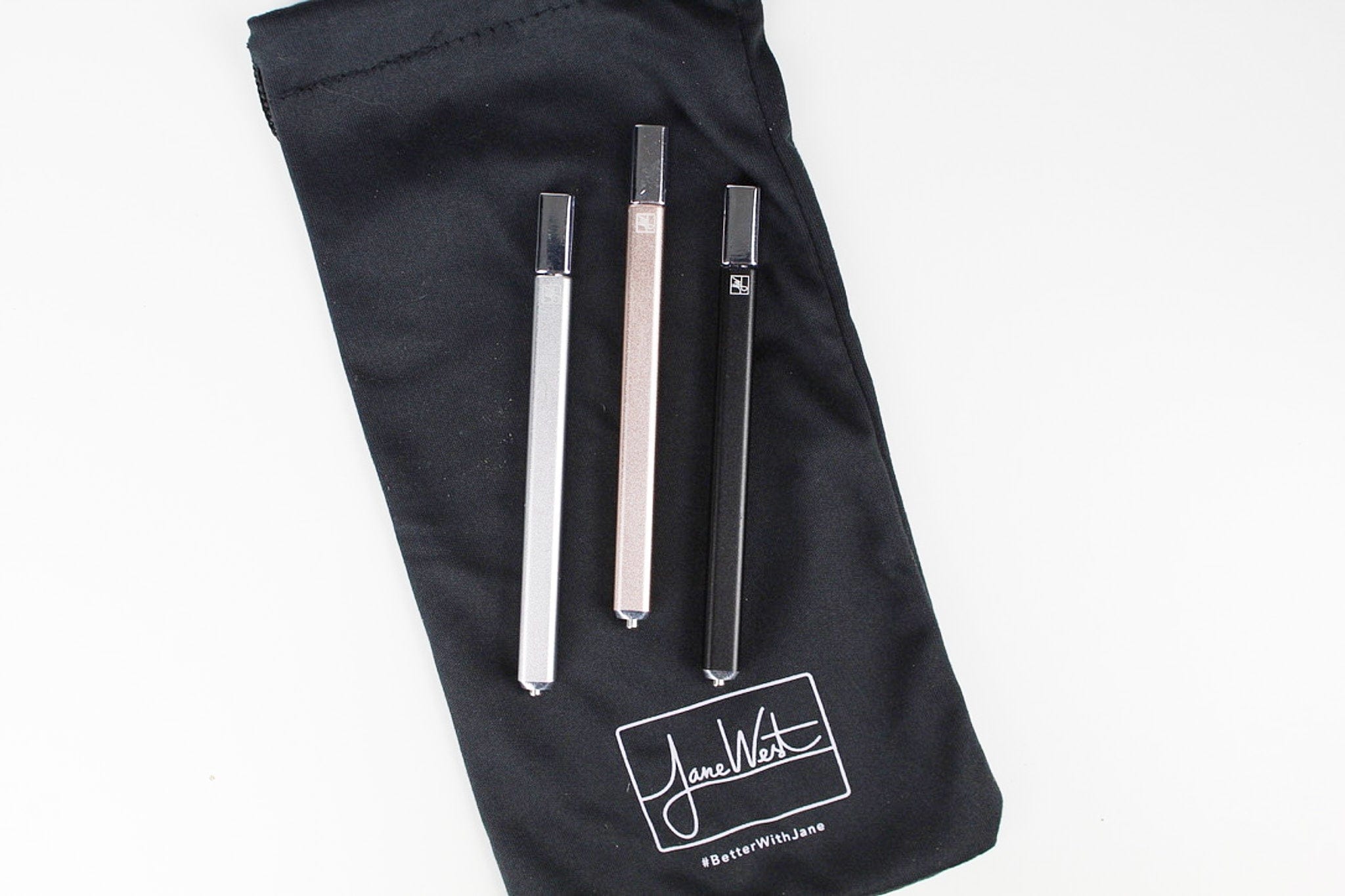 Front view of The Trio, showcasing three sleek, clear glass pieces arranged vertically on a dark background.