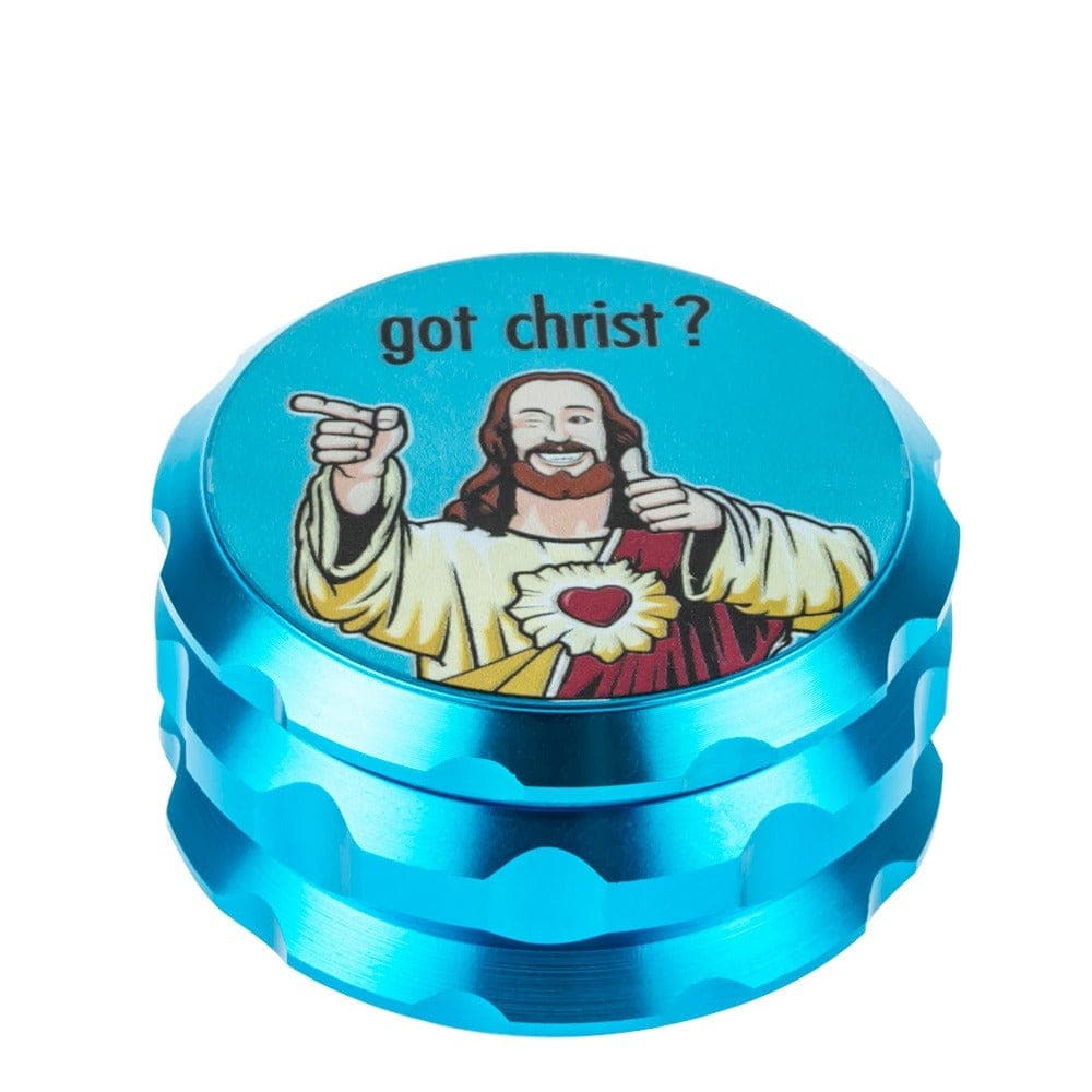 A close-up, angled view of the Buddy Christ Grinder, featuring a colorful depiction of Christ on its metallic blue surface.