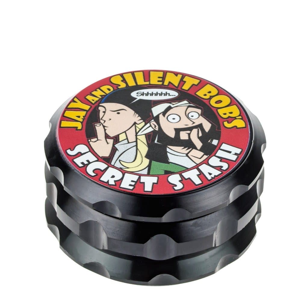 A close-up, angled view of the Jay and Silent Bob's Secret Stash Grinder with a multi-tiered, dark metal design.