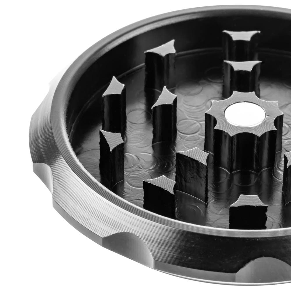 A close-up, angled view of the Buddy Christ Grinder’s internal grinding teeth, showcasing its metallic construction.