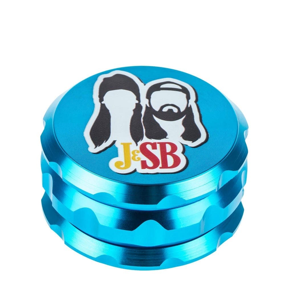 A detailed close-up of the Buddy Christ Grinder, showcasing its textured, blue metallic surface and cylindrical shape.