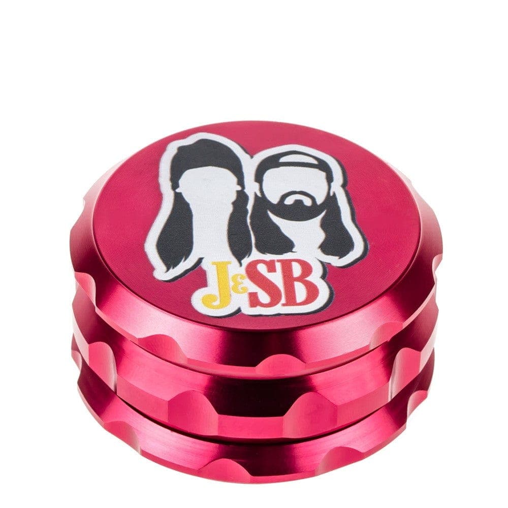 A close-up, angled view of the Jay and Silent Bob's Secret Stash Grinder, showcasing its multi-tiered, metallic design.