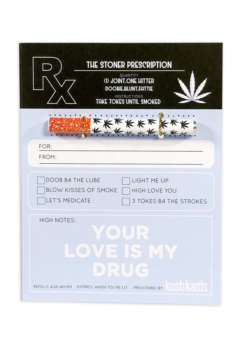 Top-down view of the 🖤 Stoner Prescription Cannabis Greeting Card showing a pen with black leaf motifs clipped to a pale blue prescription-style card reading "YOUR LOVE IS MY DRUG."